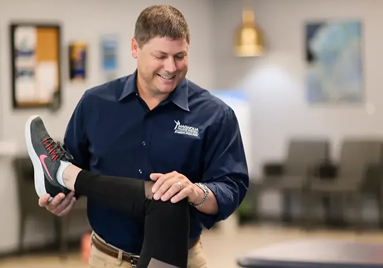 Physical therapist guiding a patient through a one-on-one treatment session