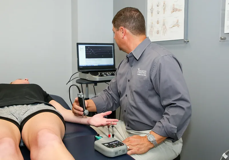 Clinician setting up therapeutic modality equipment
